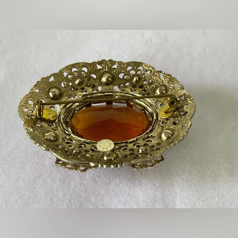 Vintage West Germany brooch featuring a large amber topaz glass filigree gold